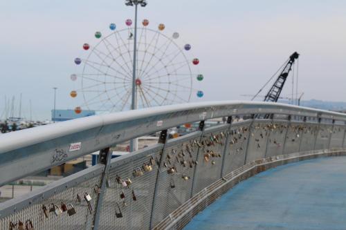 a bridge with a ferris wheel in the background at B&B Pescara Centro Luxury Suite in Pescara