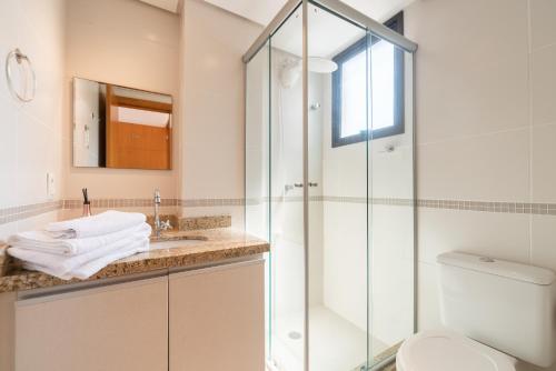 a bathroom with a shower and a sink and a toilet at Apartamento Rua Casemiro de Abreu, 199 in Porto Alegre