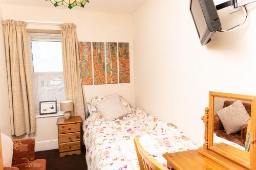Ένα ή περισσότερα κρεβάτια σε δωμάτιο στο Bosayne Guest House