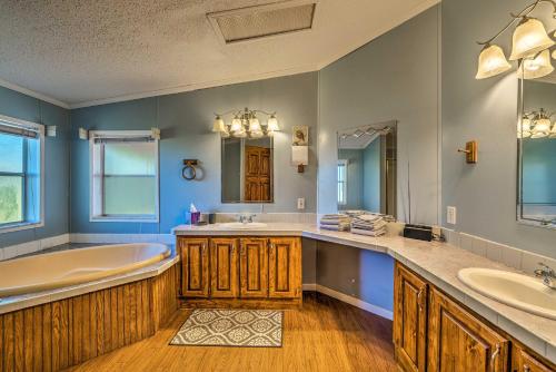 a bathroom with two sinks and a tub and a tub at Family-Friendly Home with Deck by Rainbow Springs! in Williston