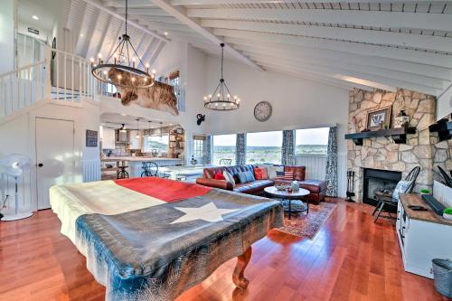 a bedroom with a bed and a living room at Spacious Getaway about 12 Acres, Views, and Hot Tub! in Strawn