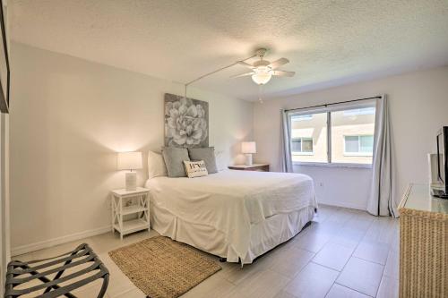 Un dormitorio con una cama blanca y una ventana. en St Augustine Getaway with Porch 1 Block to Beach!, en St. Augustine