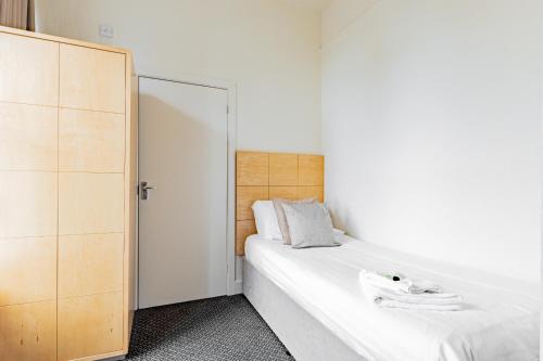 a bedroom with two beds and a closet at Brooklands Lodge in Bournemouth