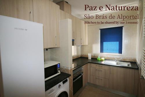 a small kitchen with a sink and a stove at Paz e Natureza in São Brás de Alportel