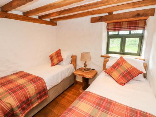 Ένα ή περισσότερα κρεβάτια σε δωμάτιο στο Blueberry Cottage