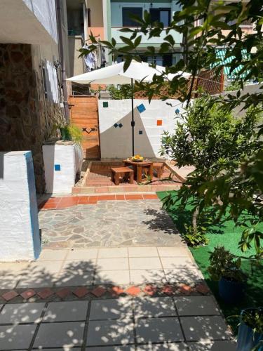 a patio with a table and an umbrella at Dwelling Zara in Solèminis