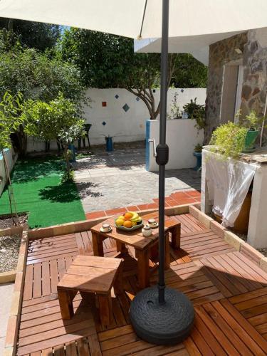 a table with a bowl of fruit and an umbrella at Dwelling Zara in Solèminis