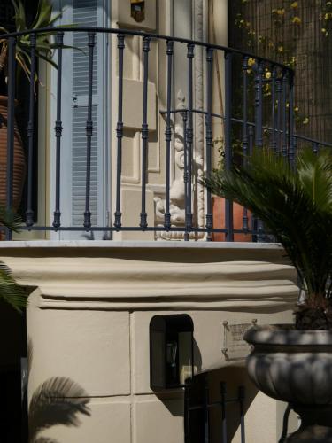 a balcony of a building with a fence and a plant at Villa Saint Hubert in Nice