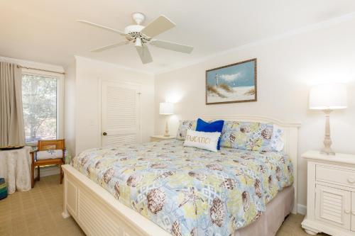 a bedroom with a bed and a ceiling fan at 1313 Pelican Watch - Seabrook Island - Beachfront 5 Star Condo - Fido Friendly in Seabrook Island