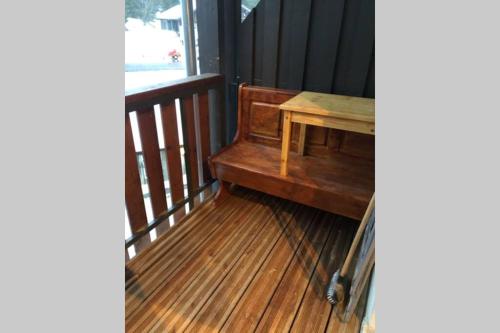 a wooden porch with a table on a balcony at Studio TMB - Le Praz de Lys in Le Praz de Lys