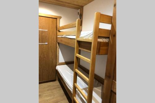 a room with two bunk beds and a door at Studio TMB - Le Praz de Lys in Le Praz de Lys