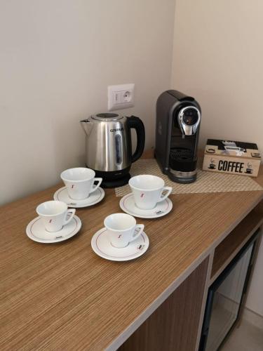 three cups and saucers on a counter with a coffee maker at MaLù BEST Rooms - Tropea in Tropea