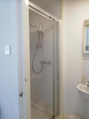 a shower with a glass door in a bathroom at Elderslie Guest House in Oban