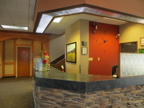 a lobby with a stone counter in a building at Athabasca Valley Inn & Suites in Hinton