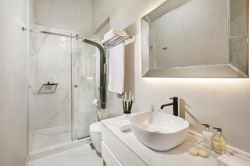 a white bathroom with a sink and a shower at MiraMe Athens Boutique Hotel in Athens