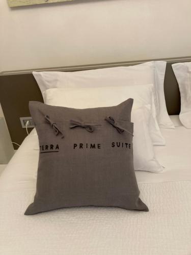 a pillow with a bow tie on a bed at Terra Prime Suite in Riomaggiore