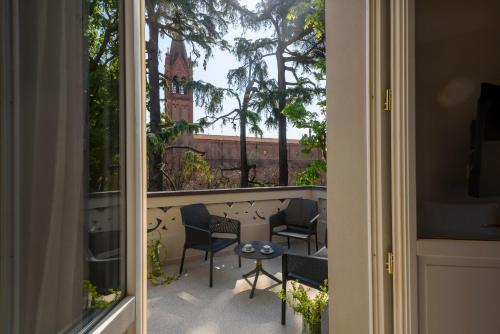 a view of a balcony with chairs and a table at Mysuiteshome Apartments in Bologna