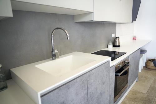 a kitchen with a large white sink in it at 36 Metri quadri in Polignano a Mare