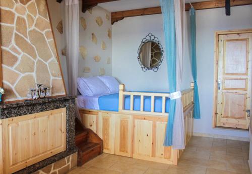 a small bedroom with a bed and a door at Villa Limnioni in Archangelos