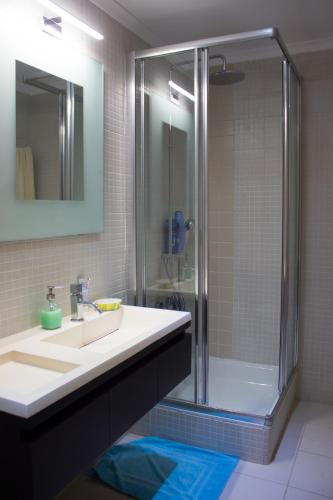 a bathroom with a sink and a shower at Ericeira (S. Lourenco) Apartment in Ribamar