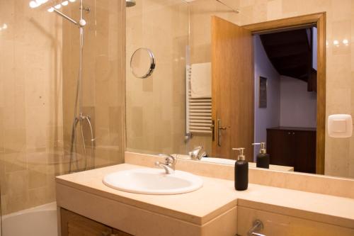 a bathroom with a sink and a shower at Ericeira (S. Lourenco) Apartment in Ribamar