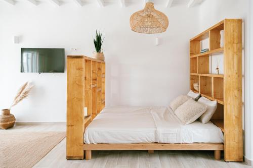 a bedroom with a wooden bed and shelves at SilvAir II by Silvernoses, Mykonos in Dexamenes