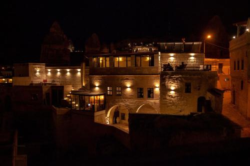 a building with lights on it at night at Sato Cave Hotel in Göreme