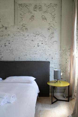 a bedroom with a bed and a yellow table at Infinite House Guglie in Venice