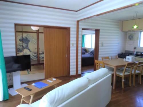 a living room with a white couch and a table at Maison Ota Building A Building B - Vacation STAY 11231 in Takamatsu