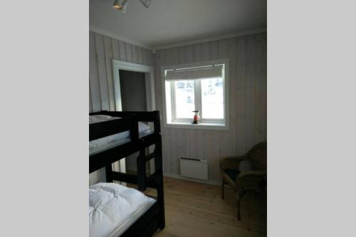 a bedroom with two bunk beds and a window at Apartment Gaustablikk in Gaustablikk