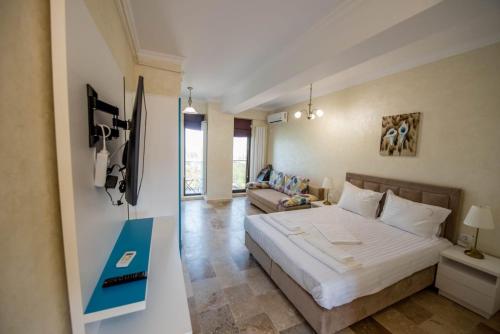 a bedroom with a large bed and a couch at Cazare Apartmente in SolidHouse Mamaia in Mamaia