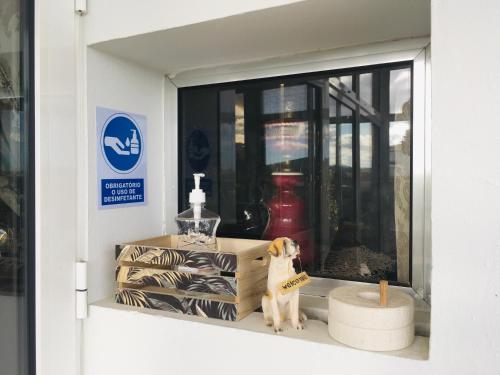 a dog figurine in a window of a building at Forever São Brás in São Brás de Alportel