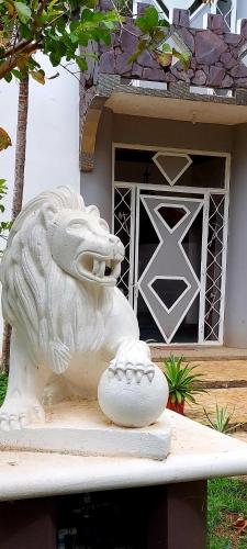 a white lion statue sitting on top of a surfboard at El Castillo Monte Campana in Puntarenas