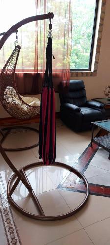 a room with a hammock and a chair and a room with at El Castillo Monte Campana in Puntarenas