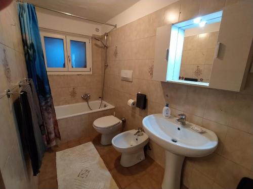 a bathroom with a sink and a toilet and a sink at La finestra sul Brenta in Lasino