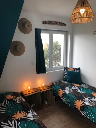 a living room with a couch and a table with candles at Au pied de la dune in Sangatte