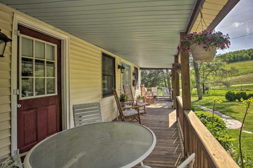 a table on the porch of a house at Spacious Faber Home with Yard, Steps to Winery! in Faber