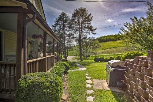a house with a trash can next to a yard at Spacious Faber Home with Yard, Steps to Winery! in Faber