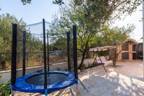 a trampoline and a blue trampoline at Villa Spark with heated pool in Rogoznica Zecevo in Zečevo Rogozničko