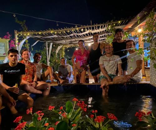 a group of people sitting around a pond at Casa La Bella Samaria Boutique in Santa Marta