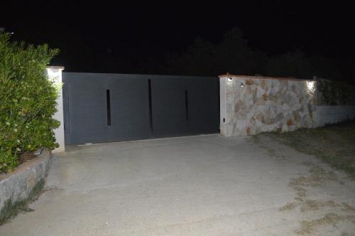 a pair of gates in a driveway at night at Casa vacanze da Anna in Tortolì