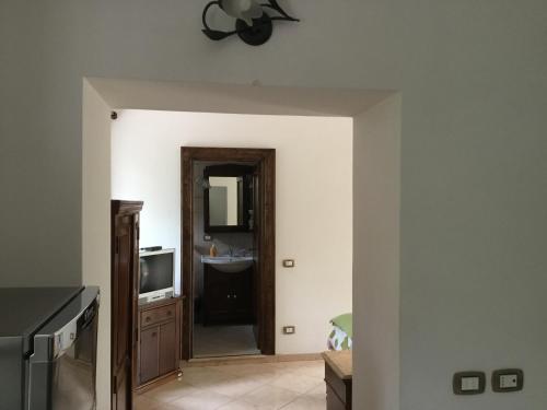 a kitchen with a door leading into a kitchen with a tv at Locanda del Ponte B&B in Balsorano Vecchio