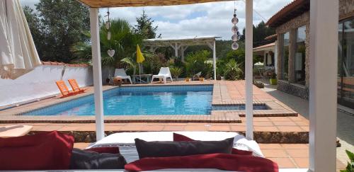 a swimming pool in a house with a patio at Casa Uldina in Bombarral