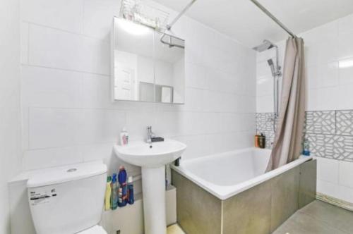 薩頓的住宿－Brunswick Rooms，浴室配有盥洗盆、卫生间和浴缸。