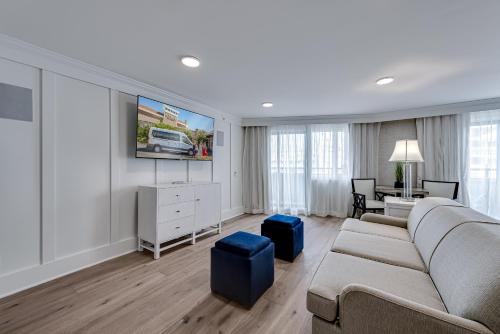 a living room with a couch and a tv at ICONA Avalon in Avalon