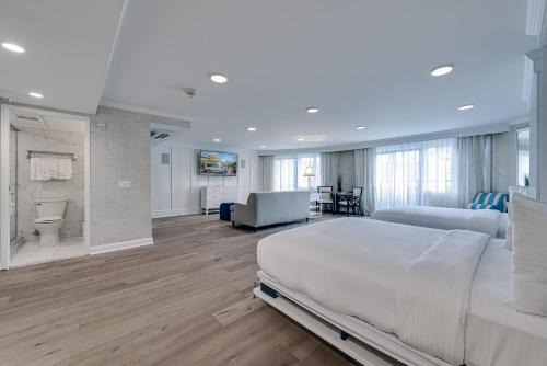 a bedroom with a large bed and a living room at ICONA Avalon in Avalon