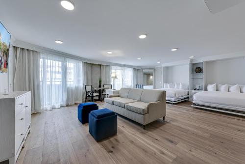 a large living room with two beds and a couch at ICONA Avalon in Avalon