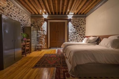 a bedroom with two beds and a table and a door at CASA SAUTO Luxury Suite in Downtown in Mexico City