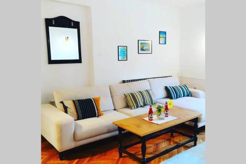a living room with a couch and a coffee table at Šumski Raj- Forest Paradise in Velika Remeta