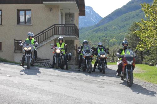 a group of people on motorcycles parked next to a building at B&B La Borella Casa Conti in Vallouise